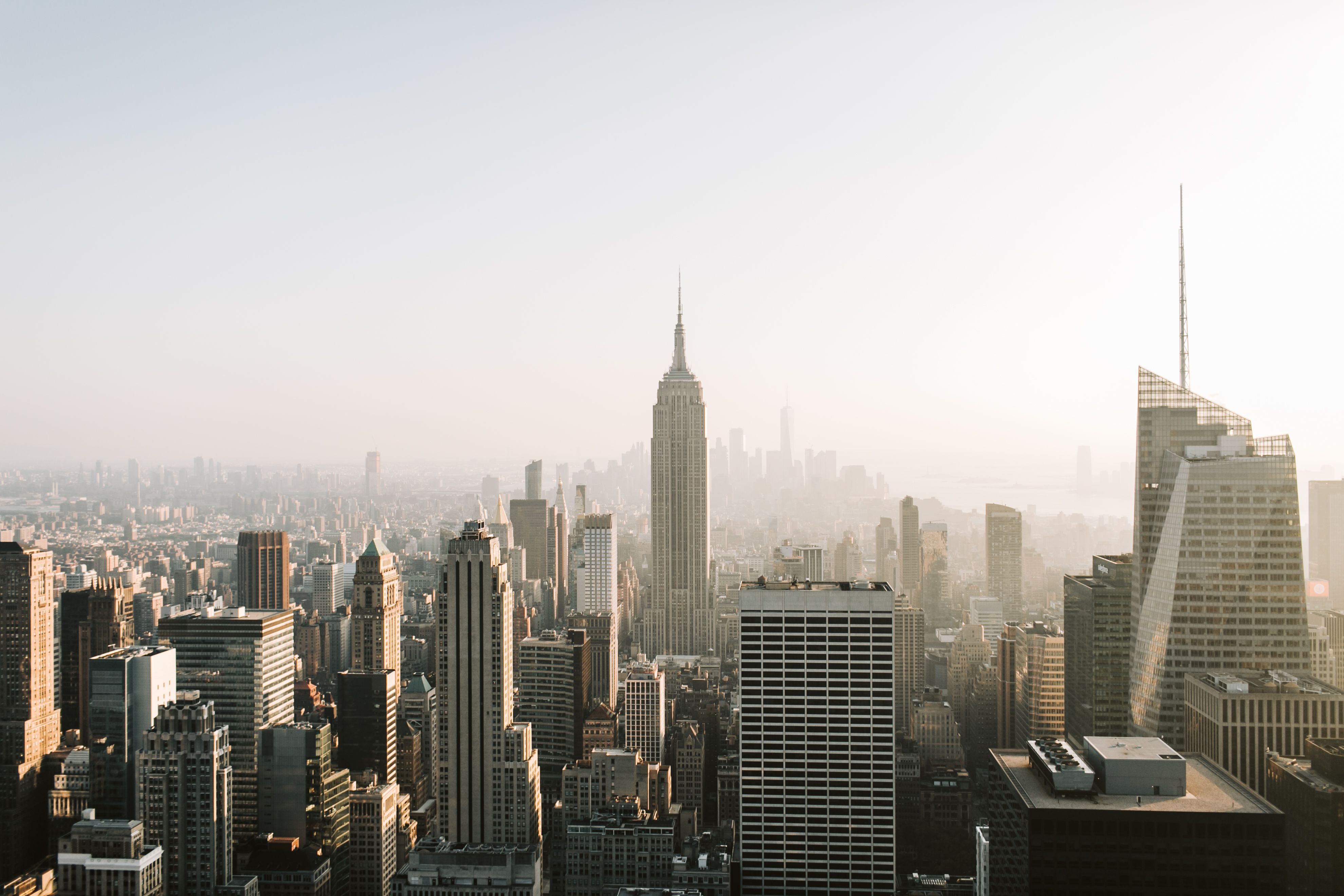 The New York City skyline at dusk, with the Empire State Building at center